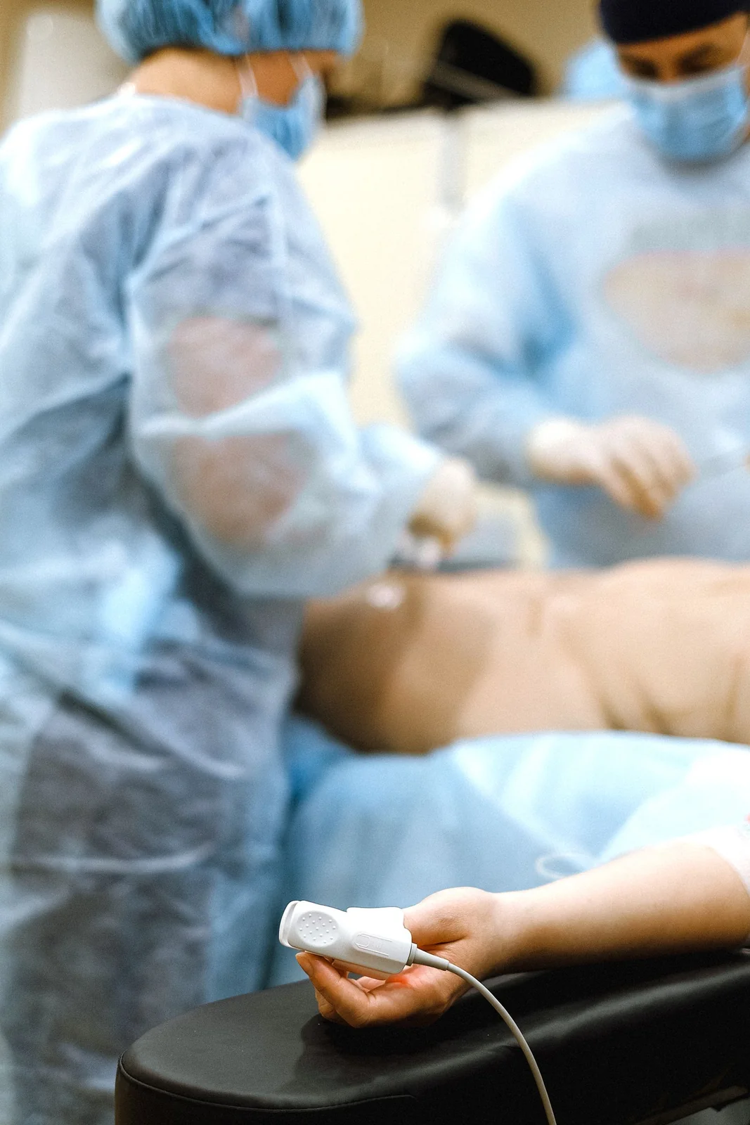 Contextual Pexels photograph of clinicians in an operating room; not Fistula Solution staff